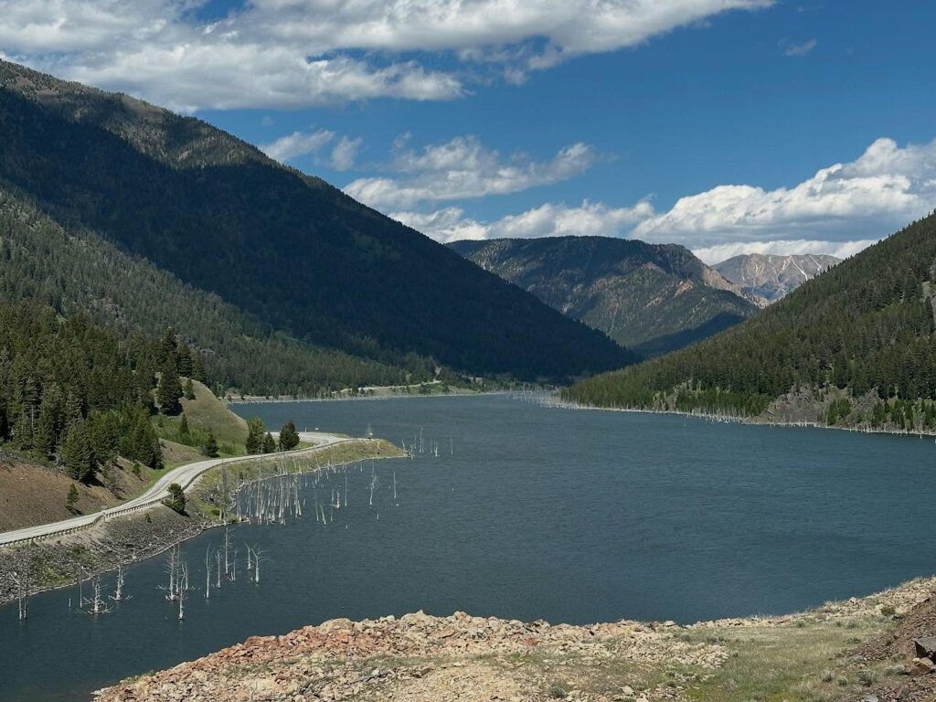 Earthquake Lake near West Yellowstone, Montana with submerged trees from the 1959 quake, a scenic stop on Highway 287 and a popular Southwest Montana sightseeing and road trip viewpoint. Photo by @flnc80 on Instagram. 