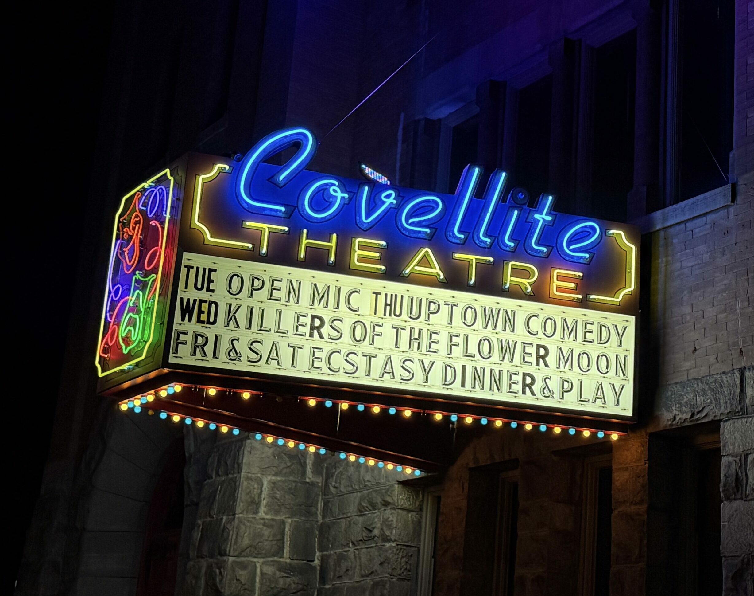 Covellite Theatre in Butte, Montana shines it's colorful lights across the historic building after dark.