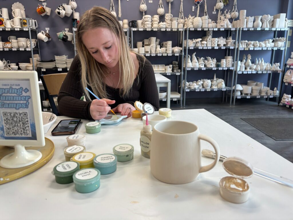 Painting pottery at a paint your own pottery studio, The Painted Pot, in downtown Helena, Montana. Photo by Alyssa Starr, Tempest Technologies.