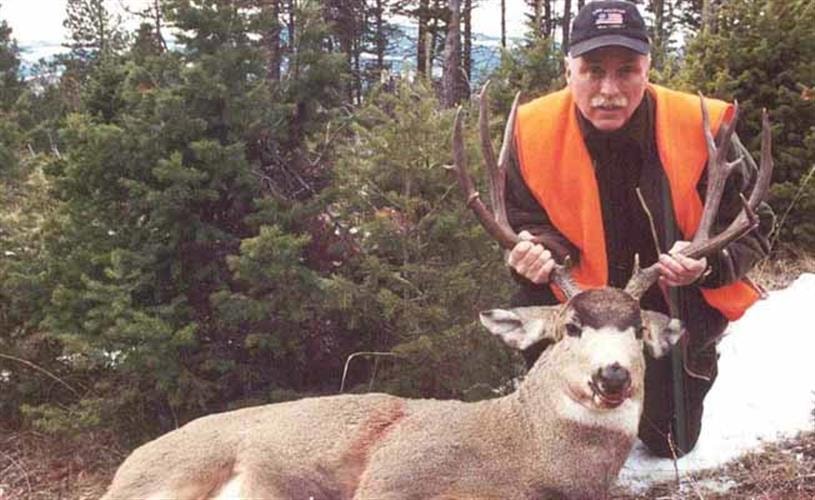 God's Country Outfitters: hunter with deer