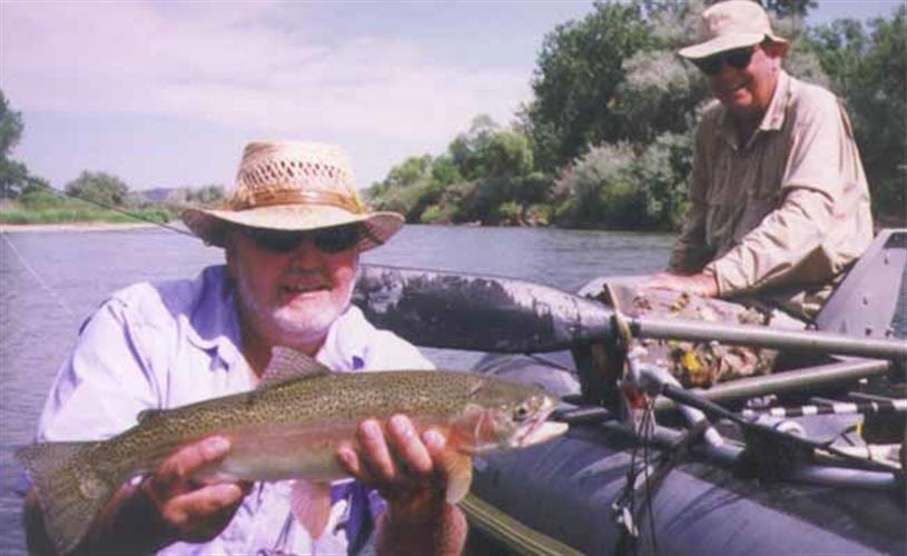 John Maki Outfitters: man in raft with fish