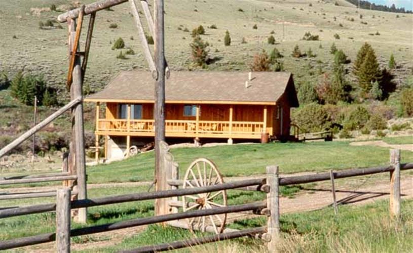 Moose Springs Ranch: cabin w/rail fence & wagon wheel