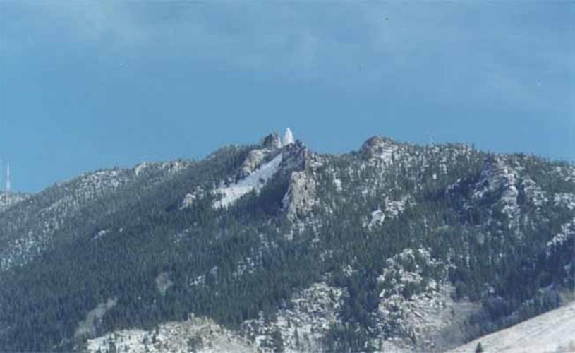 Our Lady of the Rockies Tour: statue from a distance in the mountains